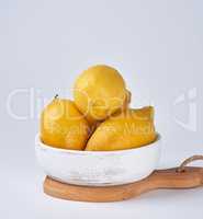 fresh ripe whole yellow lemons on a  wooden board