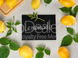 fresh ripe whole yellow lemons and black frame with an inscripti