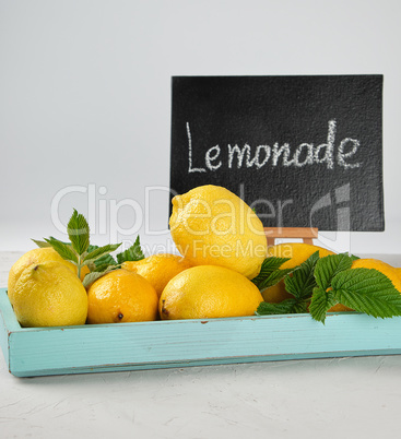 fresh ripe whole yellow lemons and black frame with an inscripti