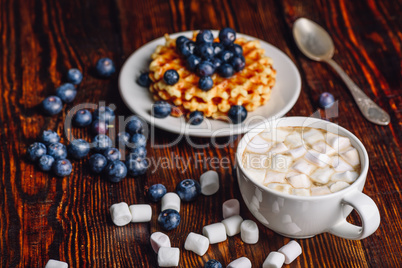 Cocoa with Marshmallow and Waffles with Blueberry.