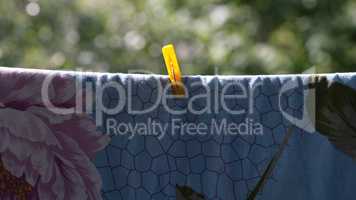 one clothespin on blue bedsheet