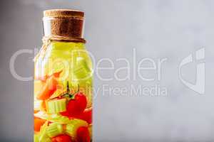 Bottle of Water with Tomato and Celery.