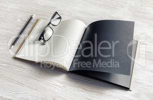 Booklet, glasses, pencil