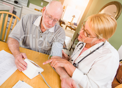 Female Nurse or Doctor Helping Senior Adult Man Take Blood Pressure