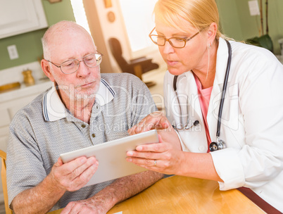 Female Doctor or Nurse Showing Senior Man Touch Pad Computer