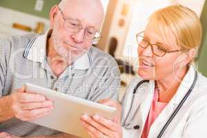 Female Doctor or Nurse Showing Senior Man Touch Pad Computer