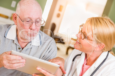 Female Doctor or Nurse Showing Senior Man Touch Pad Computer
