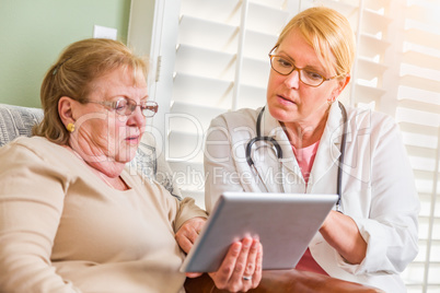 Doctor or Nurse Talking to Senior Woman with Touch Pad Computer
