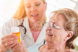 Happy Female Doctor or Nurse Explaining Prescription to Senior
