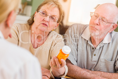 Doctor or Nurse Explaining Prescription Medicine to Senior Adults