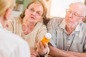 Doctor or Nurse Explaining Prescription Medicine to Senior Adults