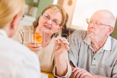 Doctor or Nurse Explaining Prescription Medicine to Senior Adults