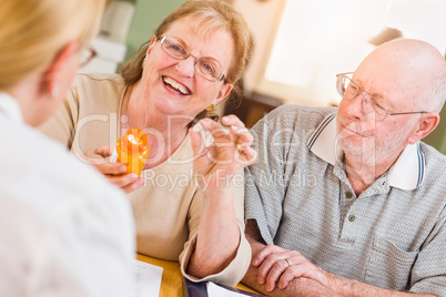 Doctor or Nurse Explaining Prescription Medicine to Senior Adults