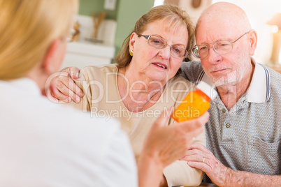 Doctor or Nurse Explaining Prescription Medicine to Senior Adults