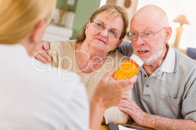 Doctor or Nurse Explaining Prescription Medicine to Senior Adults