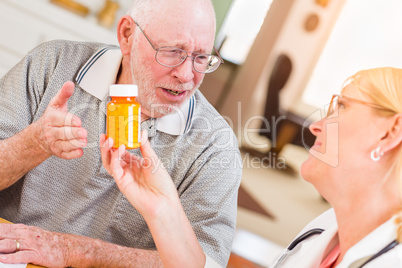 Doctor or Nurse Explaining Prescription Medicine to Senior Man