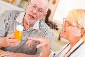 Doctor or Nurse Explaining Prescription Medicine to Senior Man