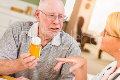 Doctor or Nurse Explaining Prescription Medicine to Senior Man