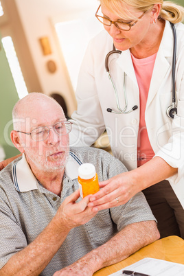 Doctor or Nurse Explaining Prescription Medicine to Senior Man