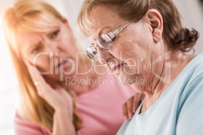 Young Adult Woman Consoles Sad Senior Adult Female