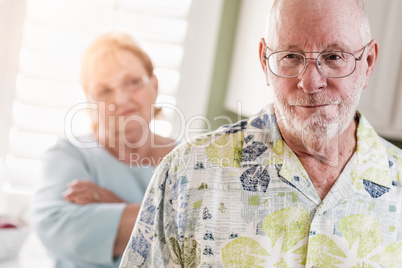 Senior Adult Couple in Dispute or Consoling in Kitchen of House