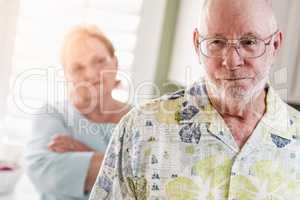 Senior Adult Couple in Dispute or Consoling in Kitchen of House