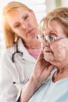 Melancholy Senior Adult Woman Being Consoled by Female Doctor
