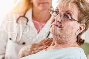 Melancholy Senior Adult Woman Being Consoled by Female Doctor