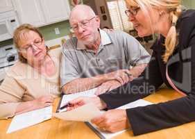 Senior Adult Couple Going Over Documents with Agent