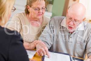 Senior Adult Couple Going Over Documents in Their Home with Agent