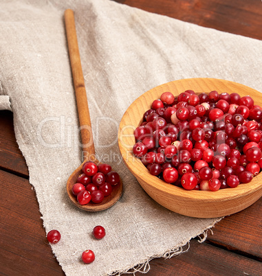 red berries of ripe lingonberries in a wooden bowl