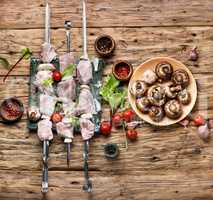Uncooked meat kebab with herbs