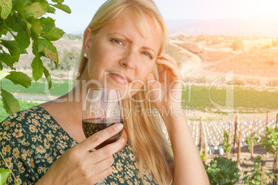 Beautiful Young Adult Woman Enjoying Glass of Wine In The Vineyard