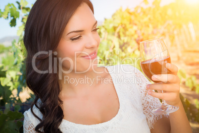 Beautiful Young Adult Woman Enjoying Glass of Wine in The Vineyard