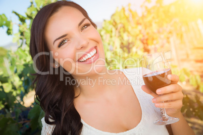 Beautiful Young Adult Woman Enjoying Glass of Wine in The Vineyard