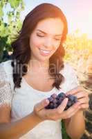 Beautiful Young Adult Woman Enjoying Grapes in a Vineyard