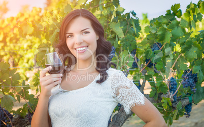 Beautiful Young Adult Woman Enjoying Glass of Wine in The Vineyard