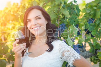 Beautiful Young Adult Woman Enjoying Glass of Wine in The Vineyards