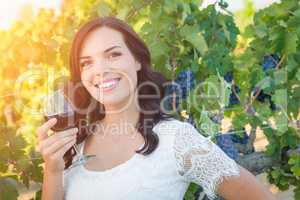 Beautiful Young Adult Woman Enjoying Glass of Wine in The Vineyards