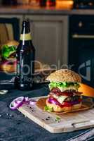 Cheeseburger on Cutting Board with Bottle of Beer