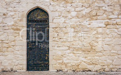 Stone Wall with Door and Oriental Engraving.