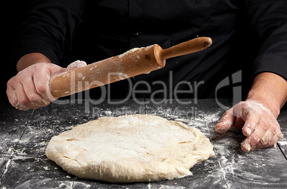 white wheat flour round dough and wooden rolling pin in male han