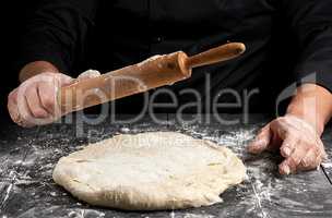 white wheat flour round dough and wooden rolling pin in male han