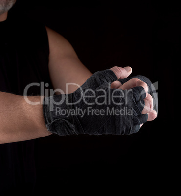 two men's hands wrapped in black sports textile bandage