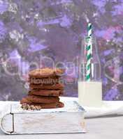 stack of round chocolate chip cookies on a brown wooden board