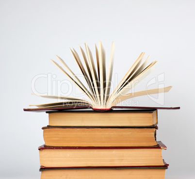 stack of books and an open book with yellow pages