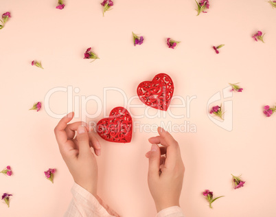 two female hands and  red hearts