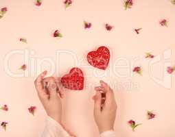 two female hands and  red hearts