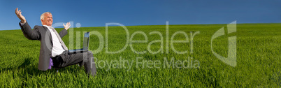 Businessman With Laptop Computer in Green Field Banner Panorama