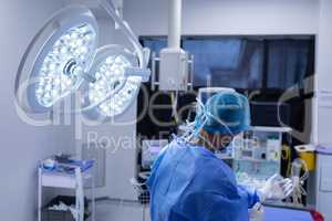 Male surgeon wearing medical gloves in operation theater